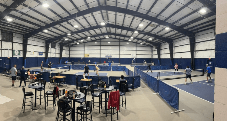 modern indoor pickleball facility with professional courts, bright lighting, clean venue