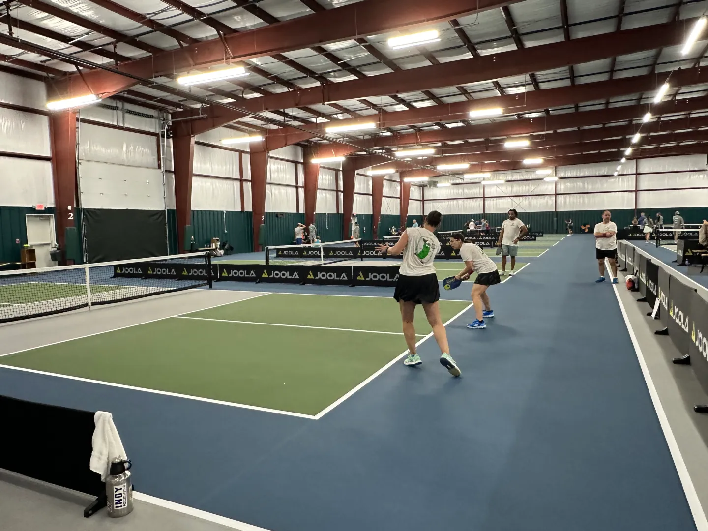 modern pickleball club with glass walls, contemporary design, upscale facility